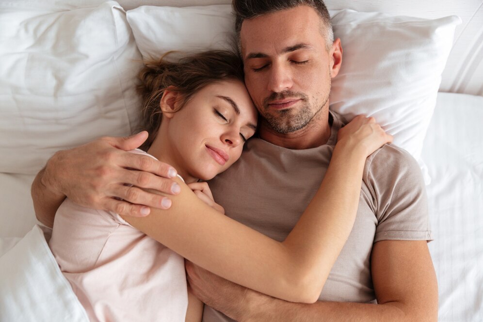 Couple cuddling in bed